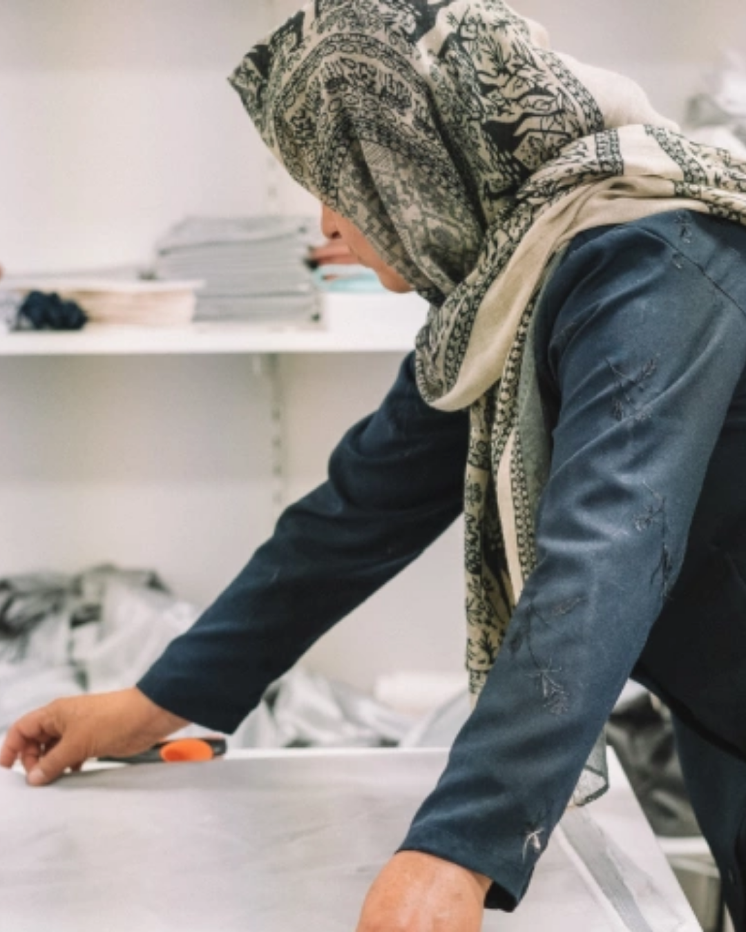 Lady making clothes at Be Hers