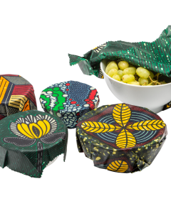 Handmade brightly coloured beeswax wraps made with African print material being used on bowls
